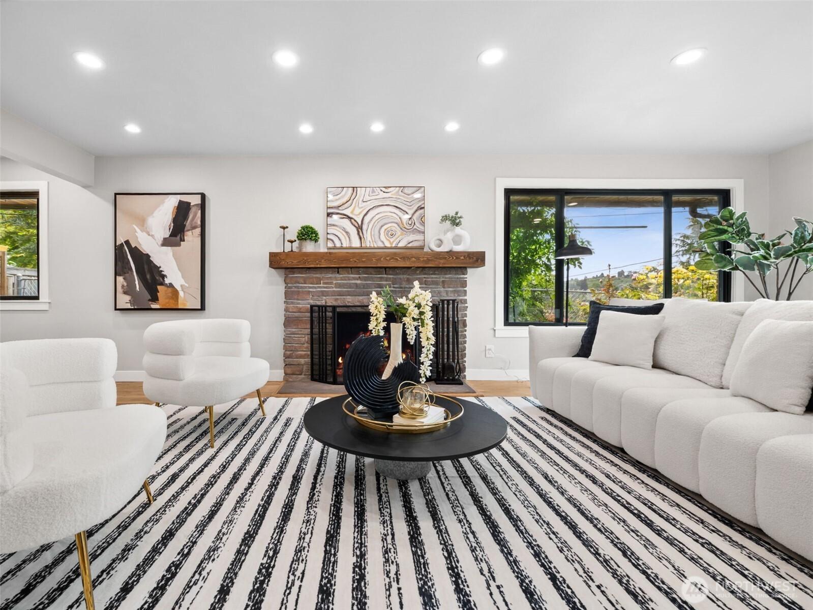 Plenty of light in this great room, with a wood-burning fireplace that can easily be converted to gas log.
