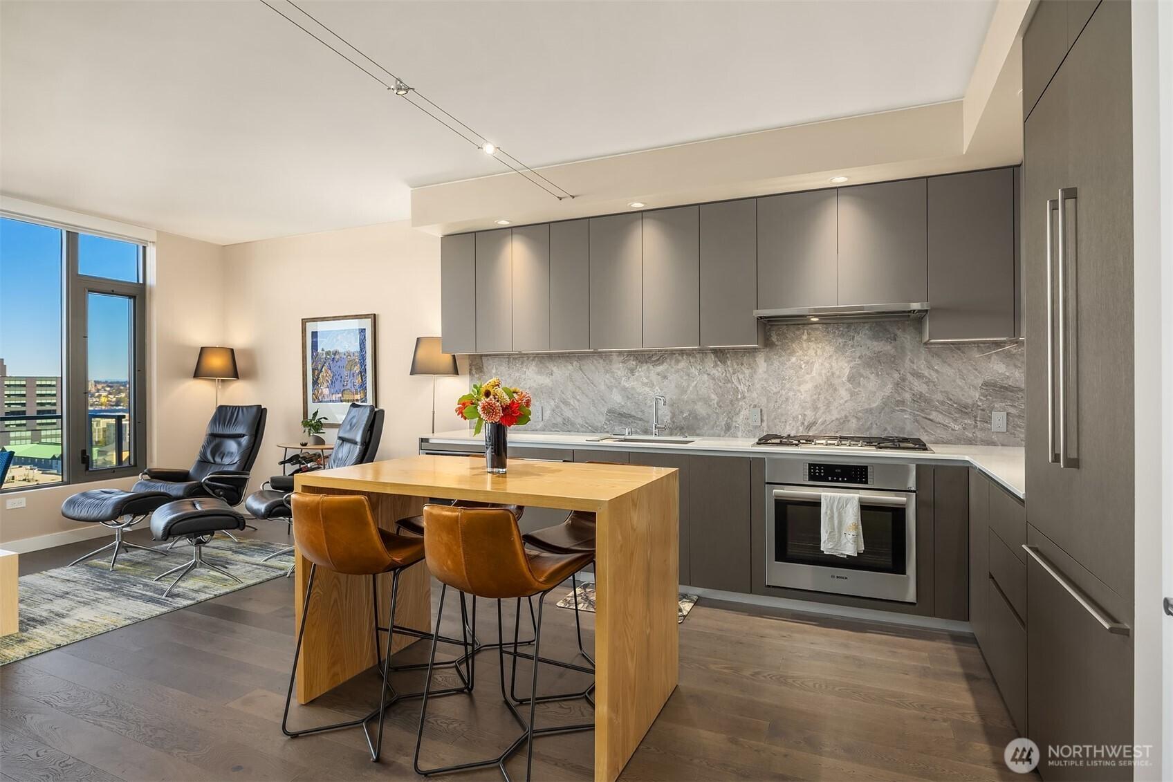 Large L shaped kitchen with Bosch appliances and custom lighting.