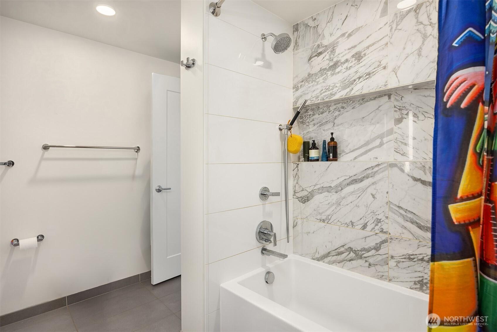 Built-in storage in this beautiful tub/shower combination.