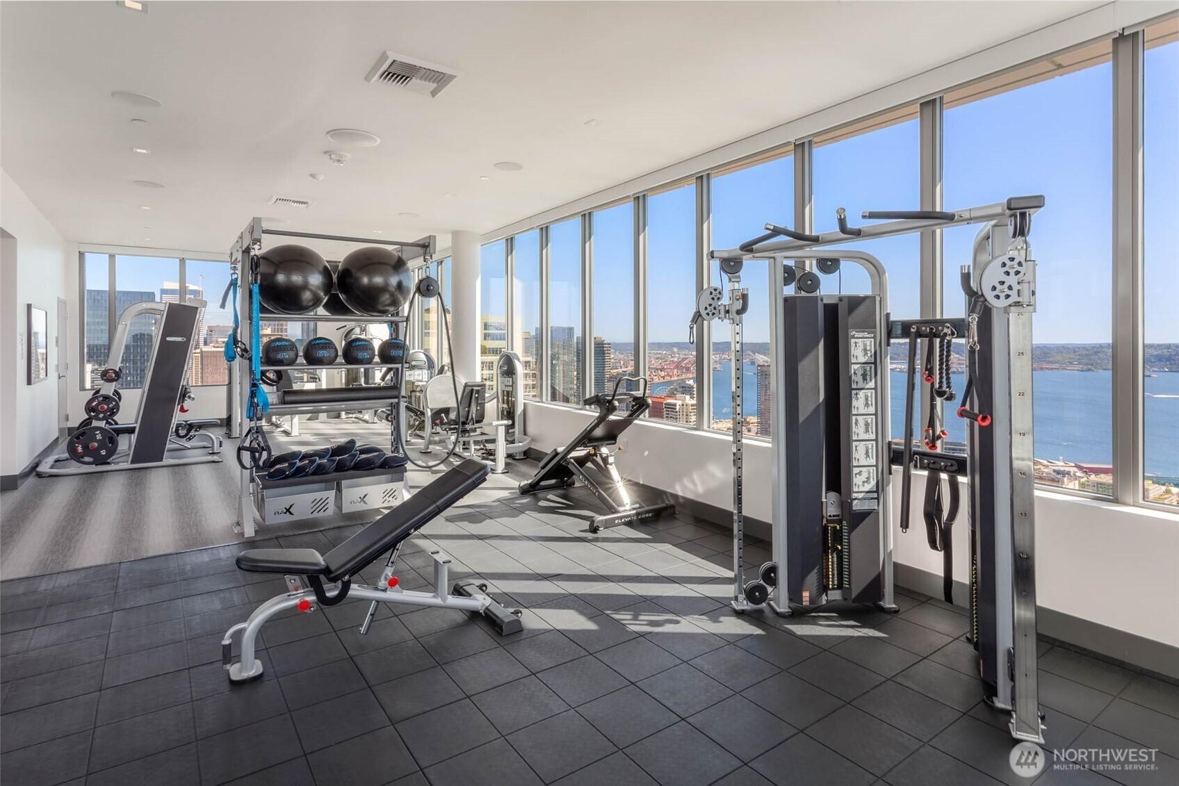 41st floor fitness center inlcludes things often not found in multi-family gyms; Smith machine for squatting and pressing without spots and free weights for bench work.